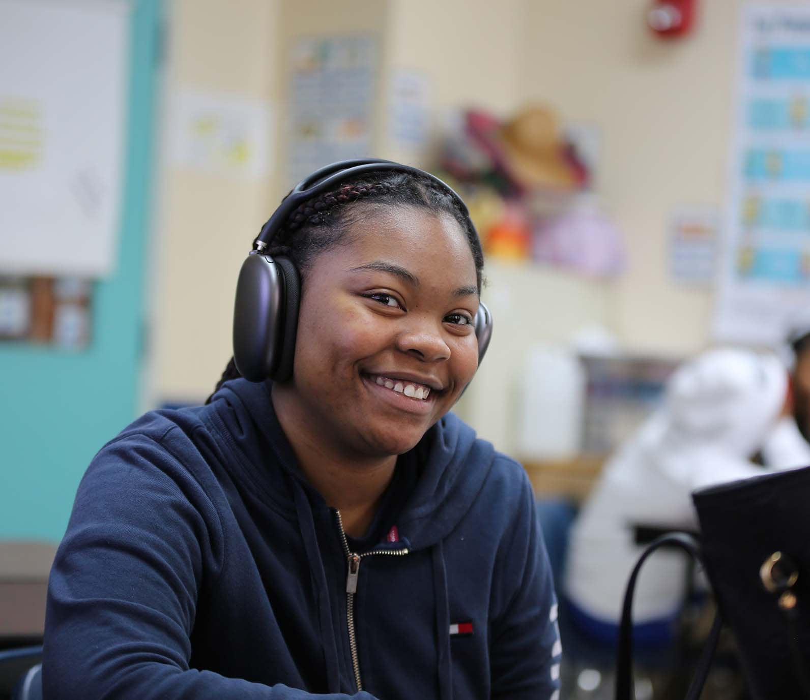 Horizon Science Academy Cleveland High student wearing headphones uses a laptop in class