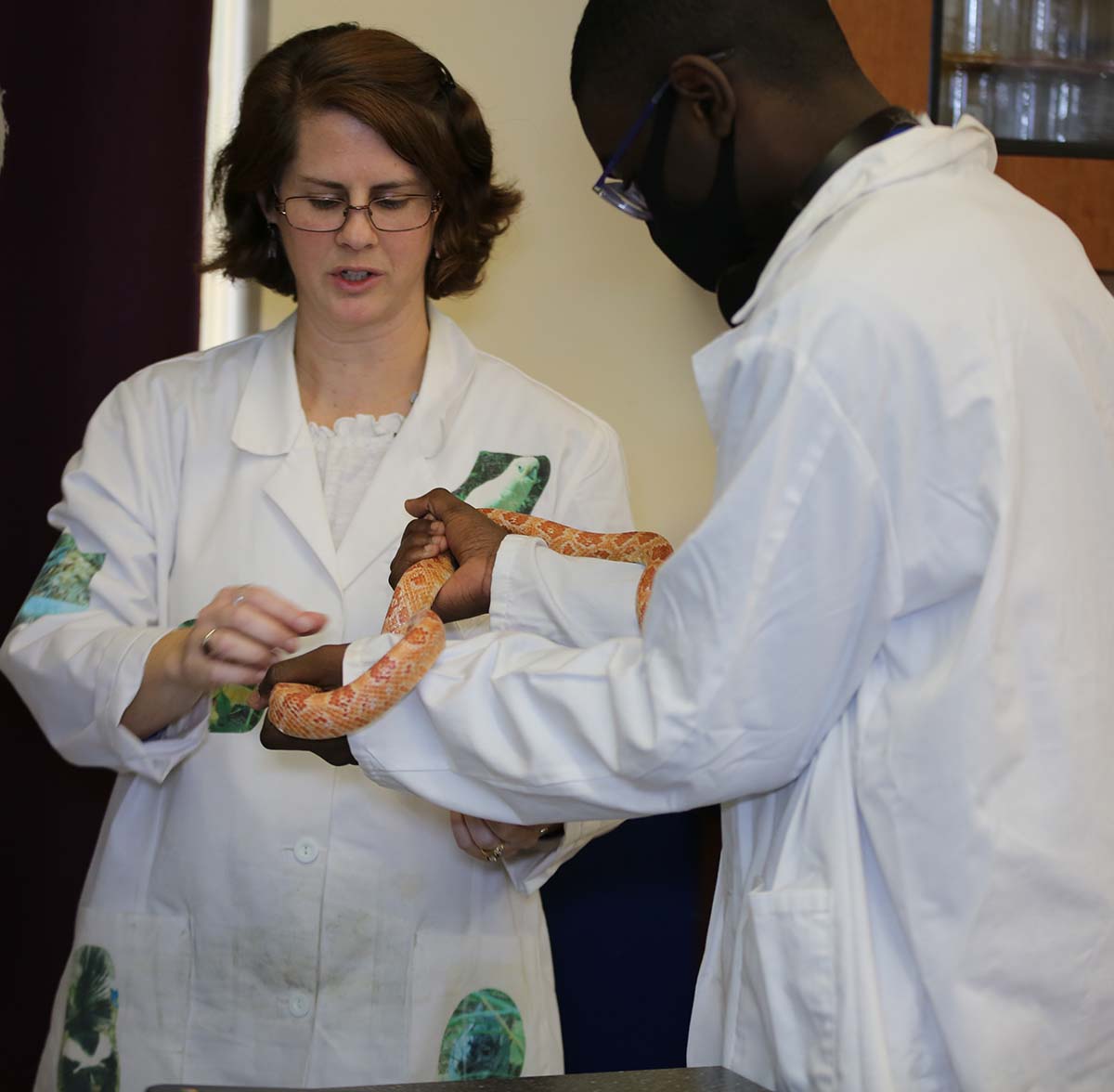 Horizon Science Academy Cleveland High Teacher and student interacting at a classroom desk
